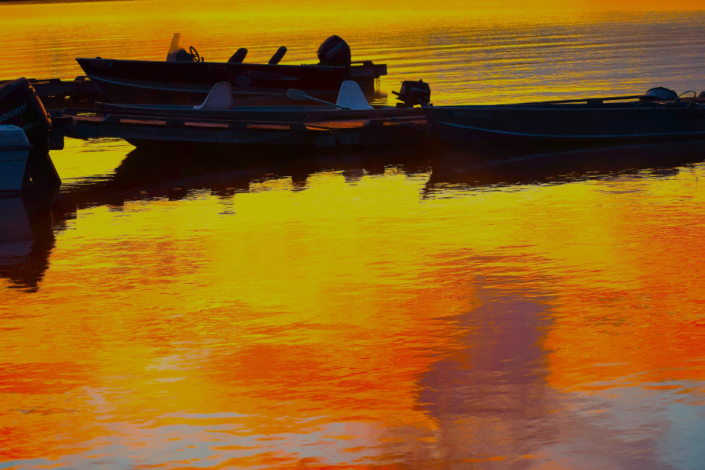 ©E. Porter, Reflections on water w boat Moosehead gloss